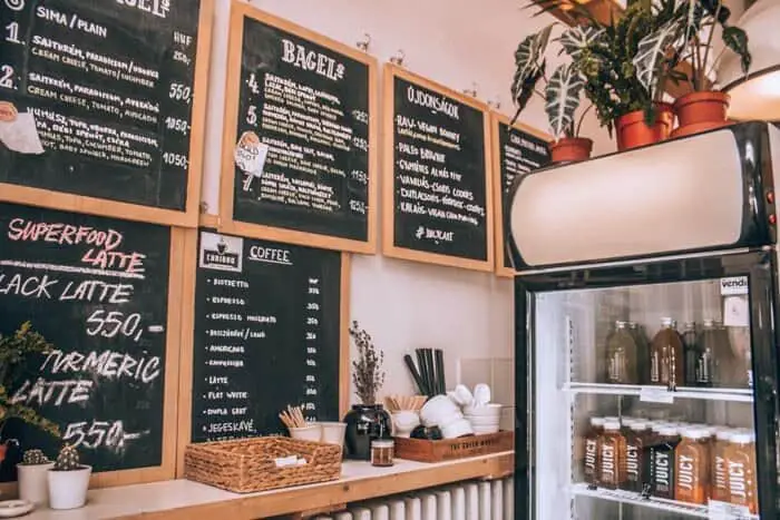 The menu and fridge at Juicy & Budapest Bagel