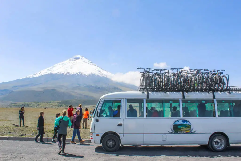 tour group and van in front of cotopaxi