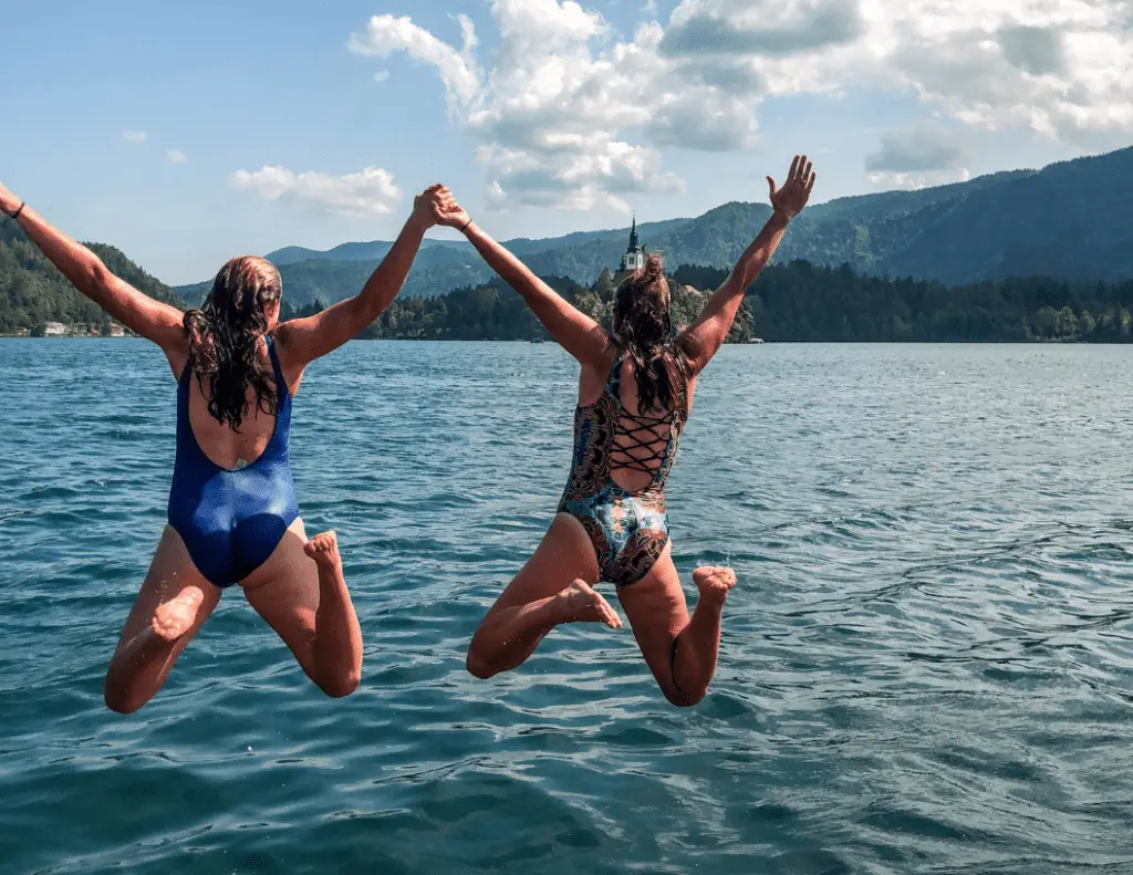 me and a friend jumping in to lake bled