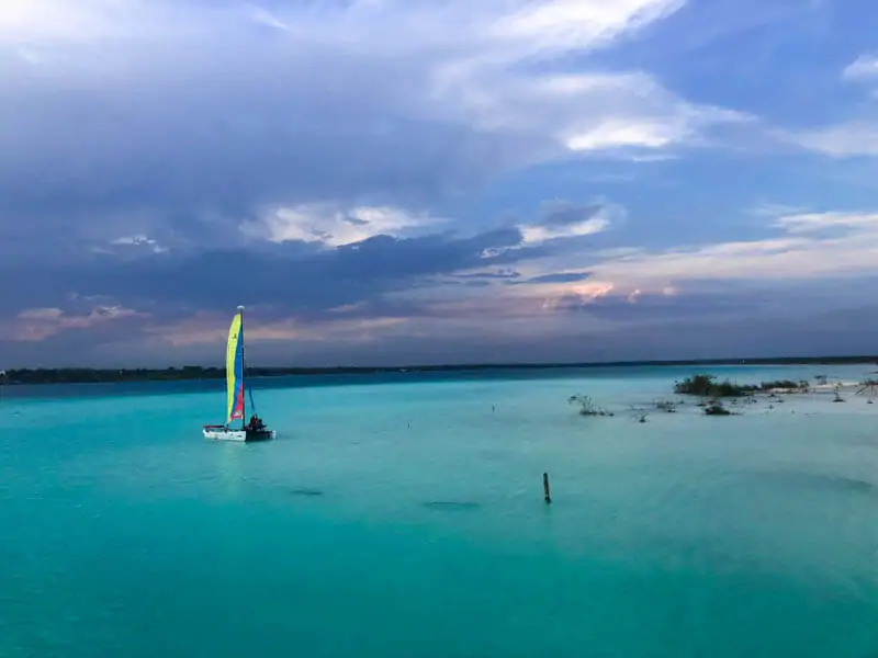 Sailboat at sunset on Laguna Bacalar in Bacalar on the Yucatan Peninsula in Mexico.