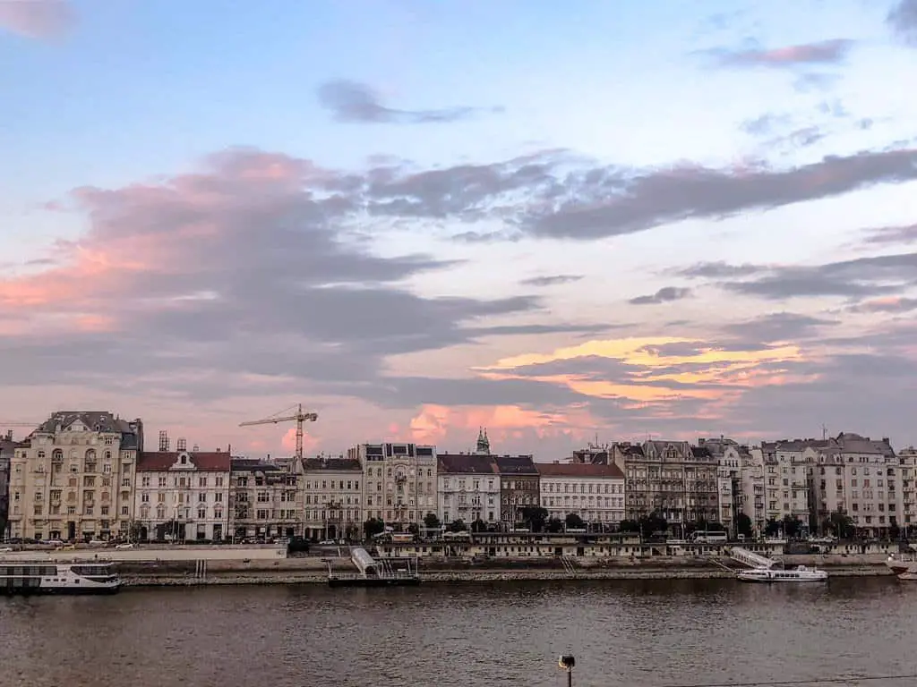 view of sunsetting over Pest from Rudas Baths