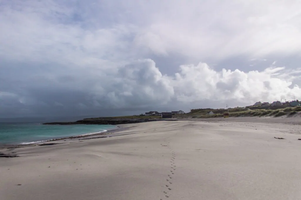 white sand beach next to the pier on inisheer