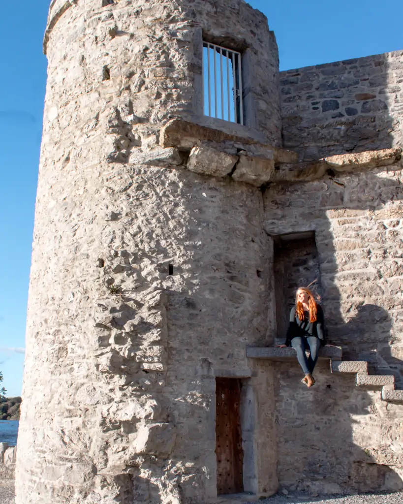 Sitting on the stairs of Ross Castle.