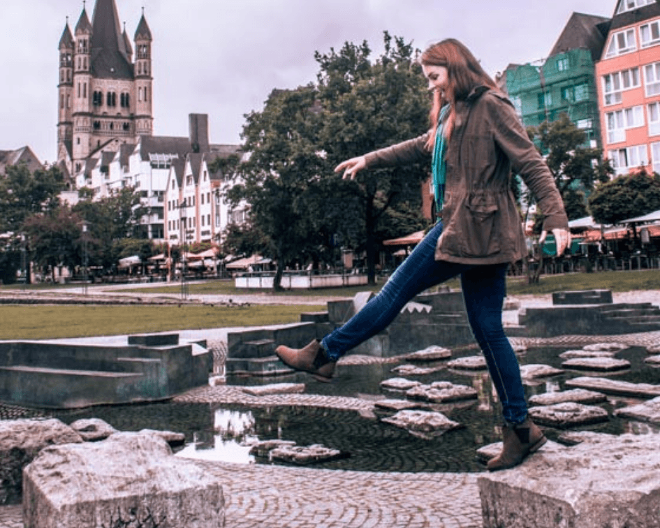 taking a big step on cobblestone streets