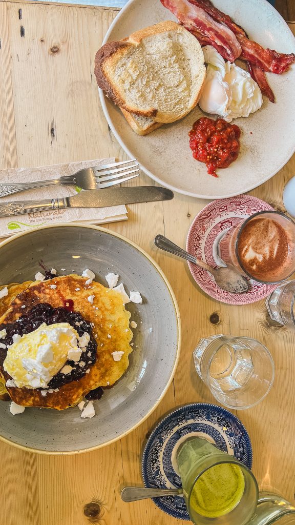 A breakfast spread at Ard Bia at Nimmos in Galway with pancakes eggs toast and coffee.