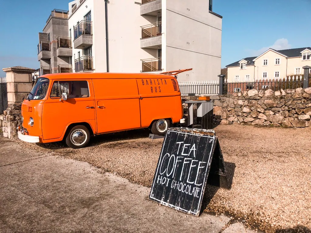 Orange bus with a sign for tea and coffee