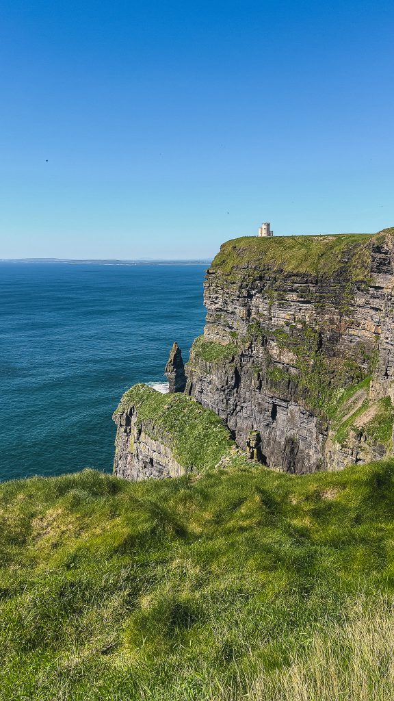 The Cliffs of Moher with a view of O'Brien's tower on a clear and sunny day.