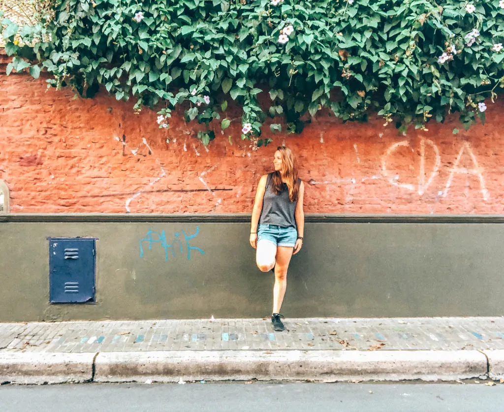 Girl standing in front of a brick wall