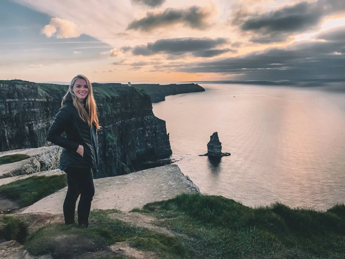 me standing in front of the Cliffs of Moher at sunset