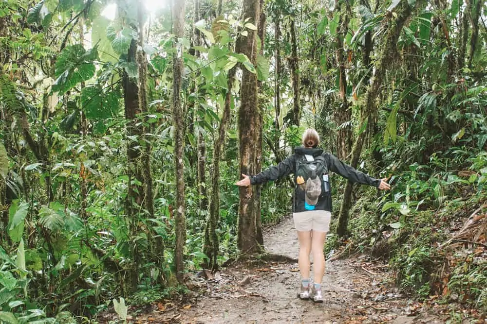 Hiking through the Mindo cloudforest in Ecuador carrying my favorite short hike backpack that holds all of my hiking essentials.