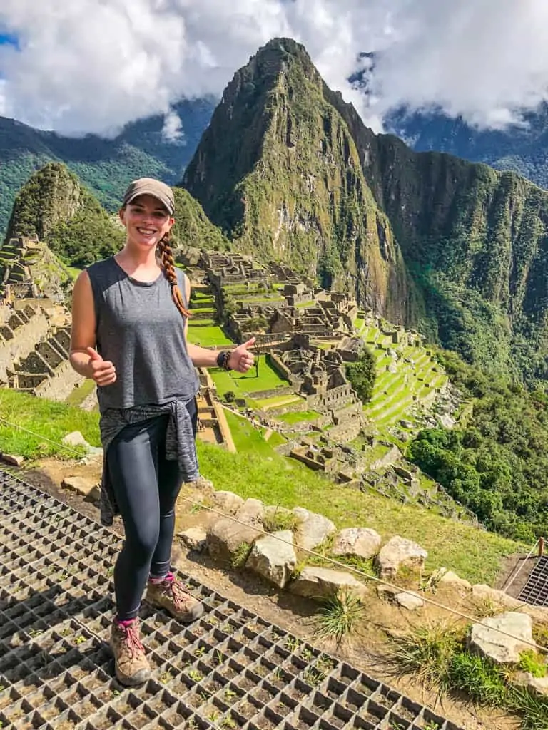 Standing in front of a Machu Picchu overlooking wearing my favorite hiking boots which were essential for happy feet on the hike to Machu Picchu.