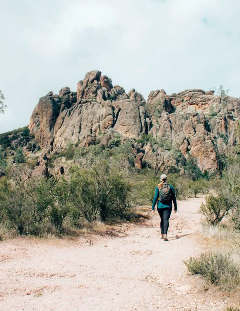 Hiking towards the high peak trail of Pinnacles National Park carrying my hiking pack essentials in a small 10L backpack