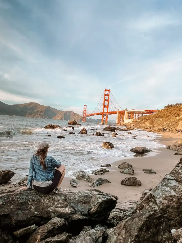 Sitting on a rock overlooking Marshall's Beach and the Golden Gate Bridge.