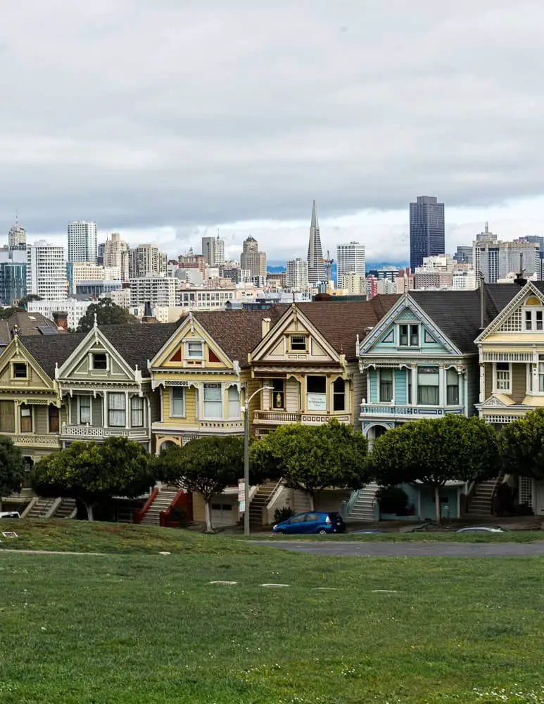 View of the Painted Ladies and San Francisco skyline from Alamo Square Park in San Francisco, CA.