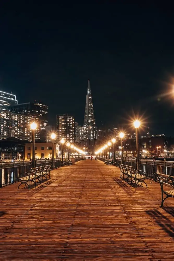 Pier 7 leading to the Transamerica Building at night.