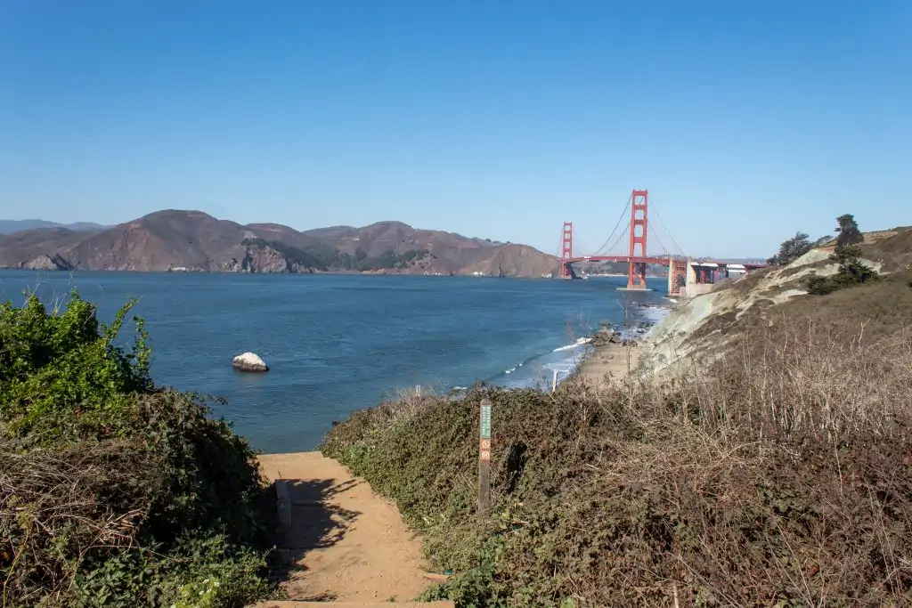 Batteries to Bluffs Trail staircase leading to Marshall's Beach and the Golden Gate Bridge in San Francisco, California.