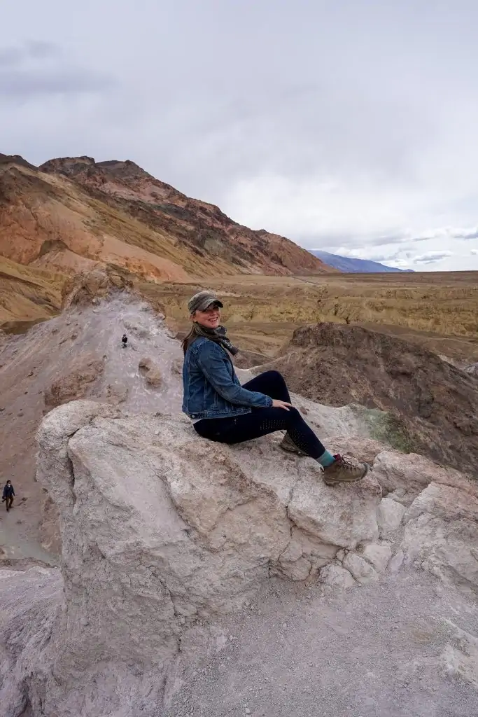 Me sitting on the pastel pink rocks of Artist's Palette Death Valley National Park