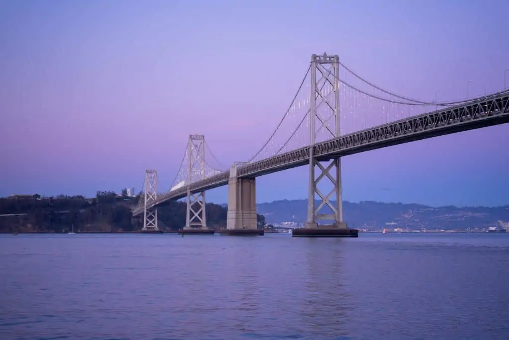 pastel sunset behind the Bay Bridge in San Francisco