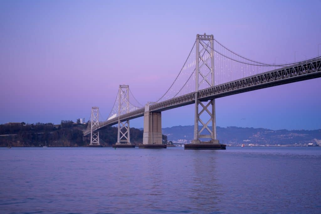 Pastel sunset behind the Bay Bridge in San Francisco, CA.