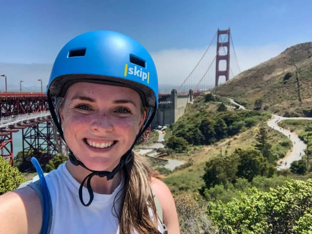 Me with a helmet on and the Golden Gate Bridge in the background