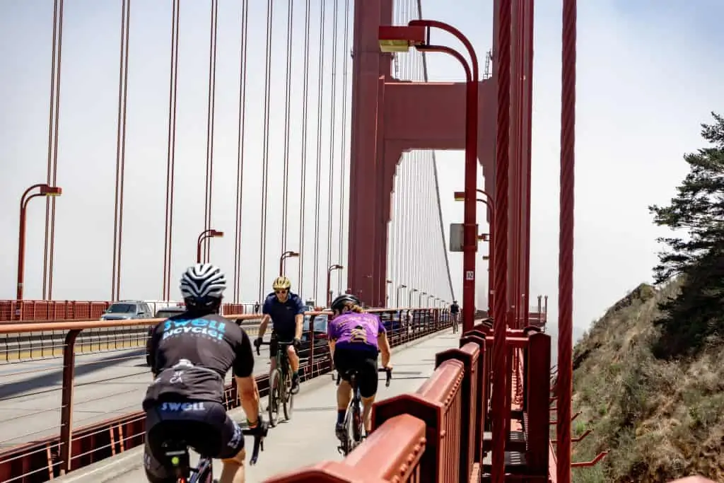 Cyclists biking across the Golden Gate Bridge