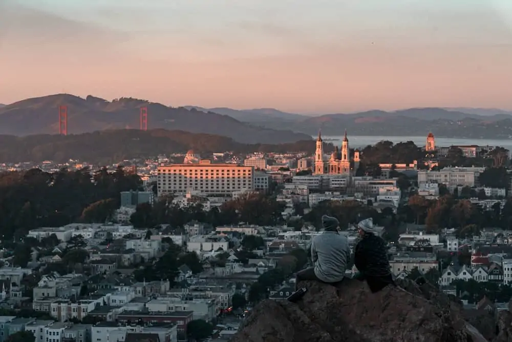 Tank Hill sunset in San Francisco with a view of the Golden Gate Bridge and Marin Headlands.
