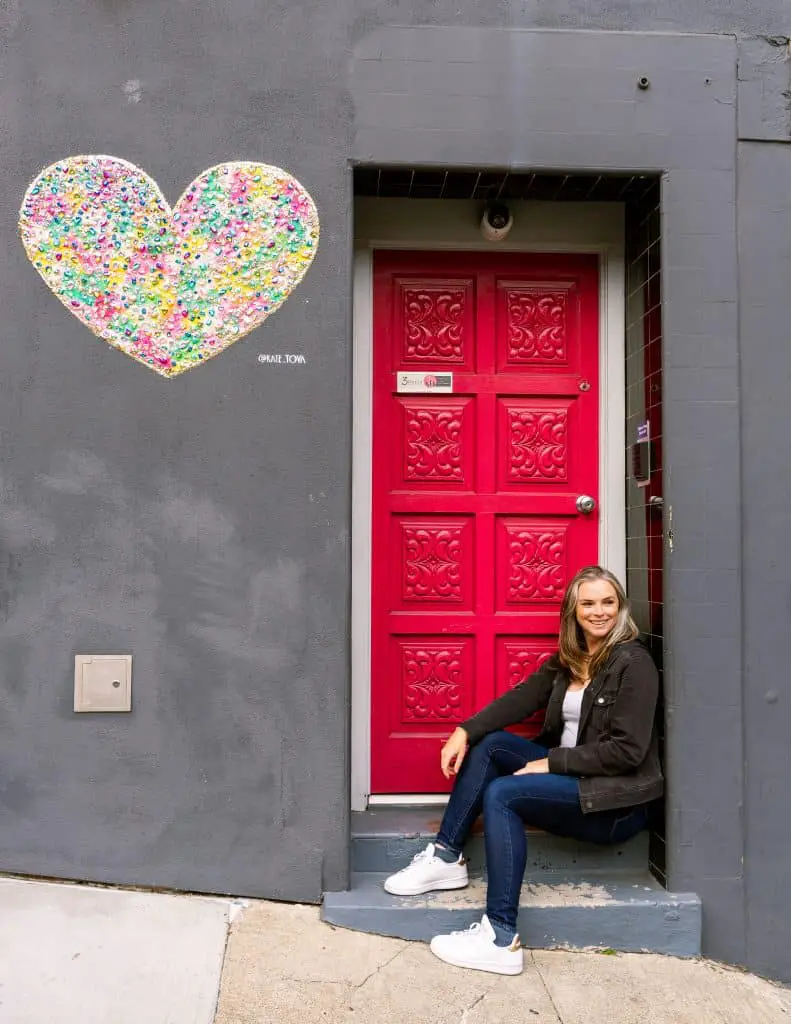 Me sitting below Kate Tova heart in North Beach San Francisco