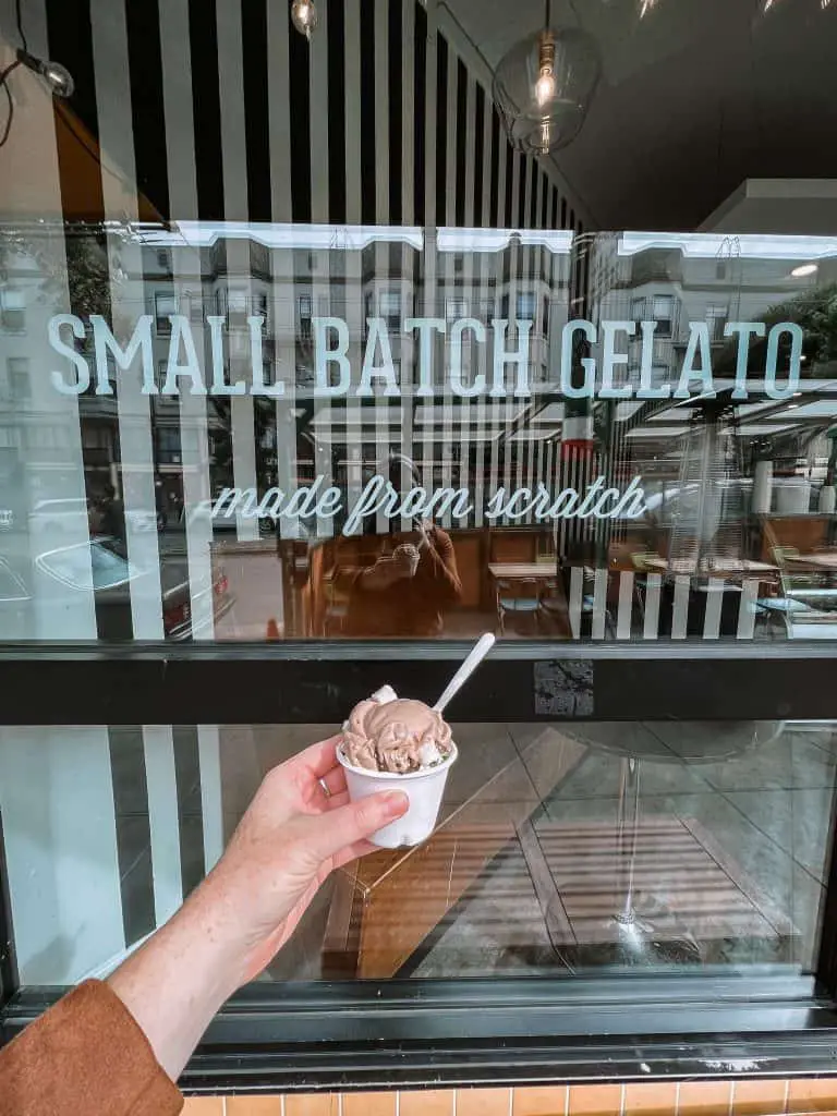 A cup of gelato held in front of Lush Gelato's window in North Beach, San Francisco.