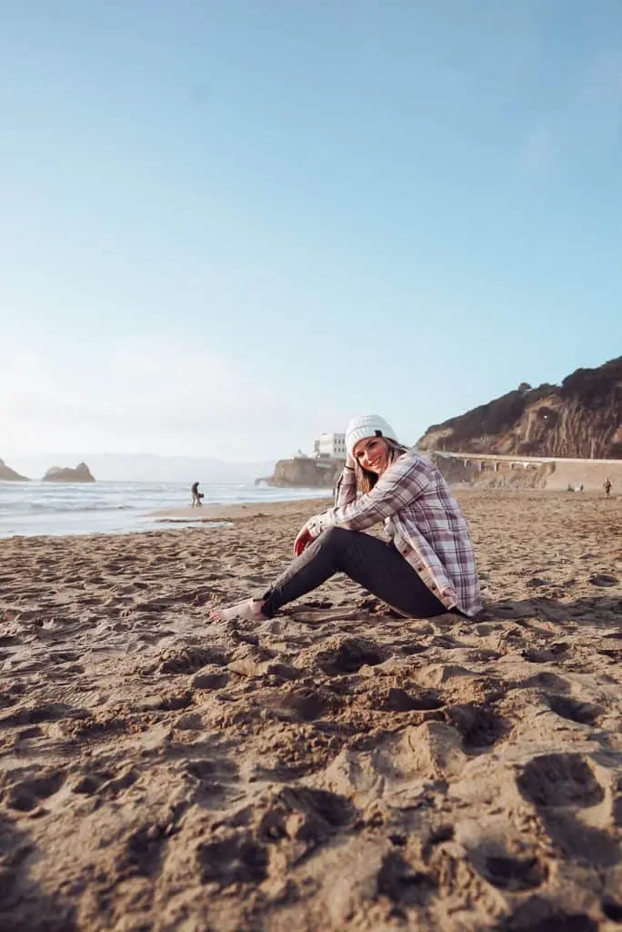 Me sitting on Ocean Beach at sunset - a great Instagram location in San Francisco