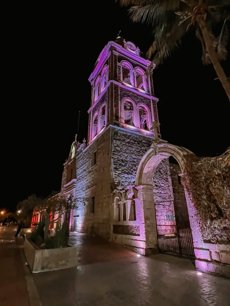 Loreto Mission at night lit up purple