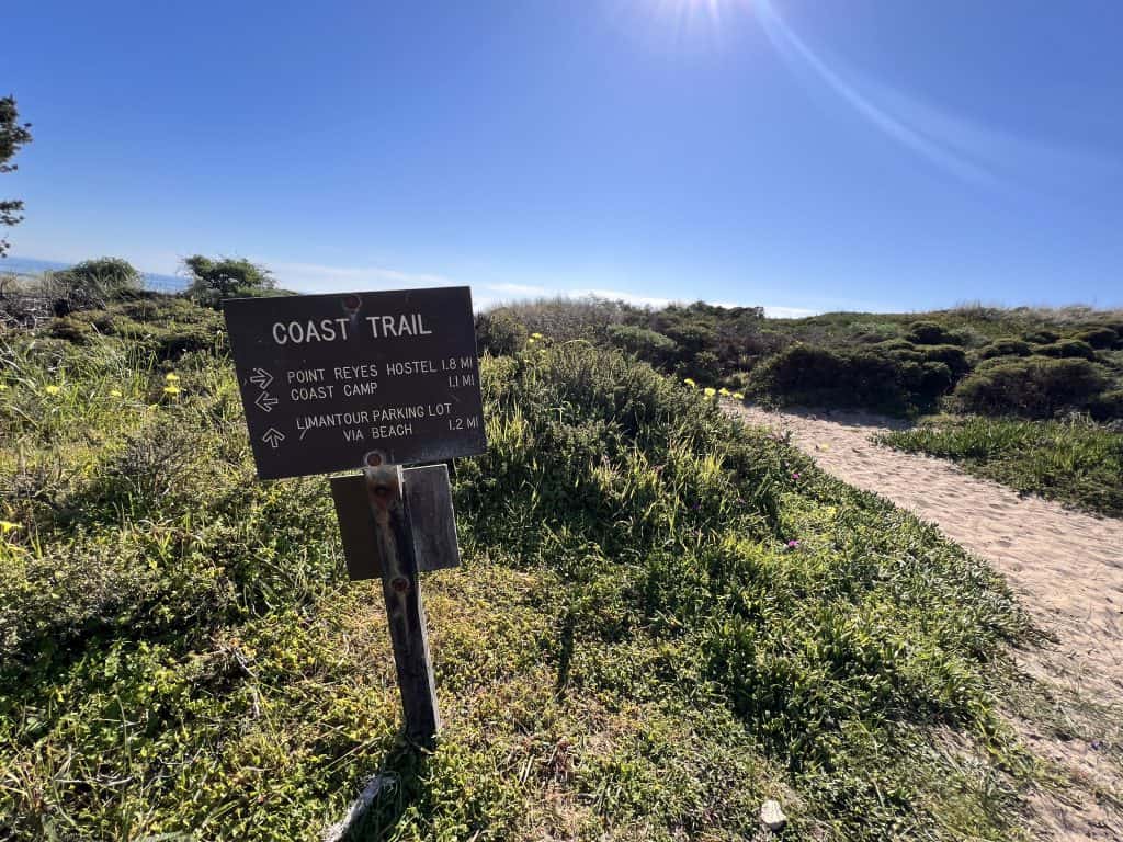 Coast trail sign and sand trail from Limantour Beach to Sculptured Beach.