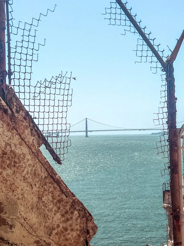 view of the Golden Gate bridge from the Alcatraz recreation yard