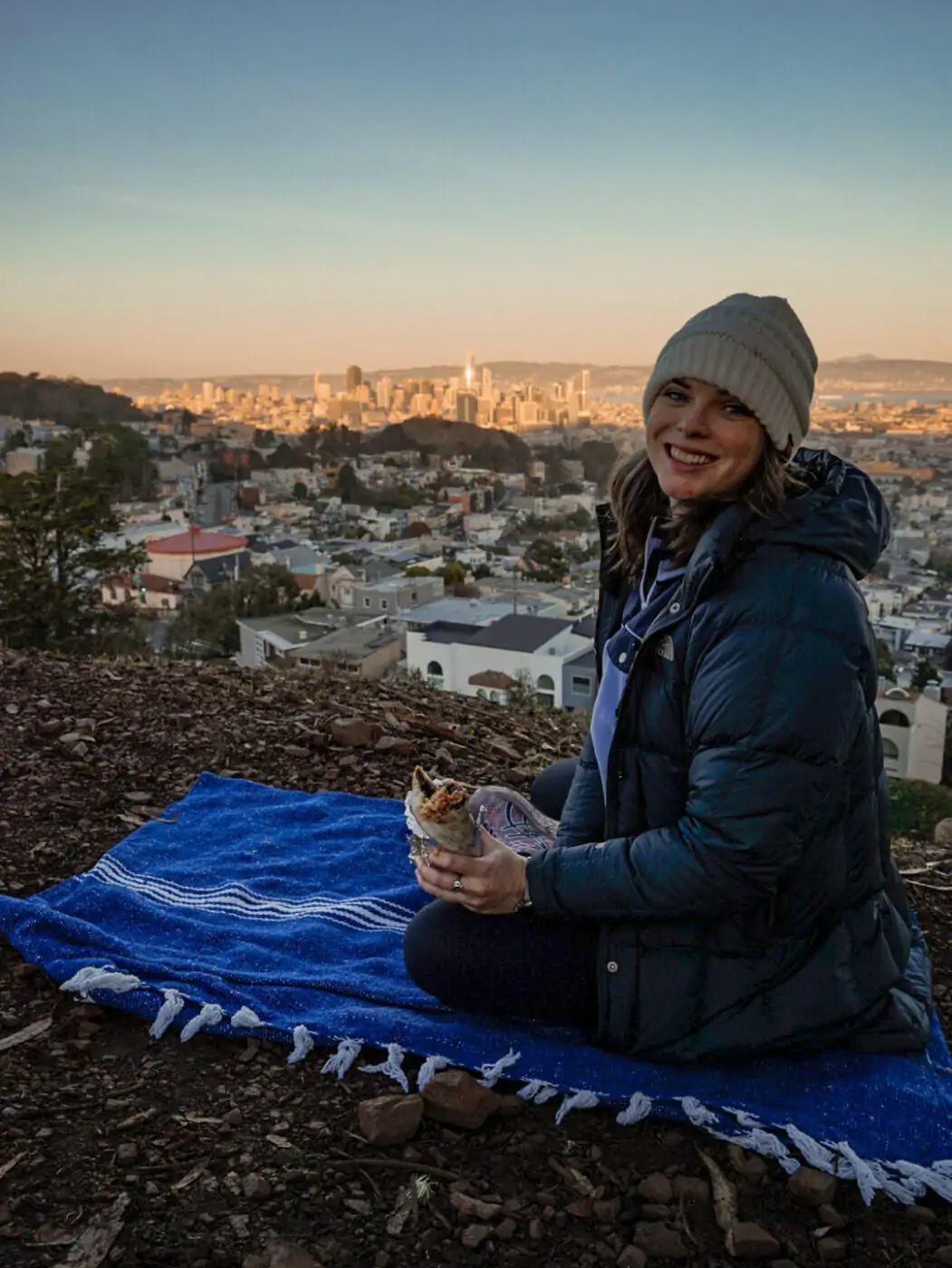Me at Tank Hill watching sunset in San Francisco while eating a Mission style burrito.