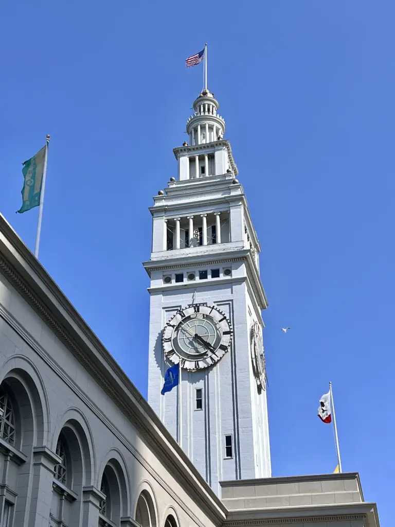 San Francisco Ferry Building clock tower against a clear blue sky.