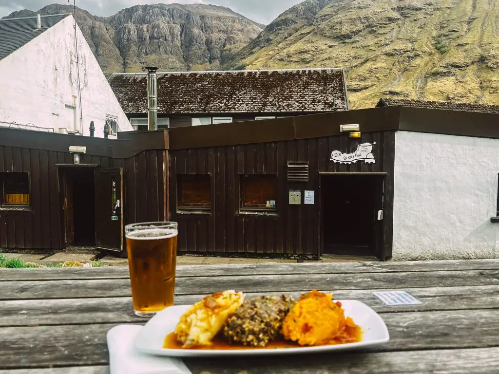 Haggis Neeps & Tatties on a picnic table outside of Boots Bar in Glencoe Scotland.