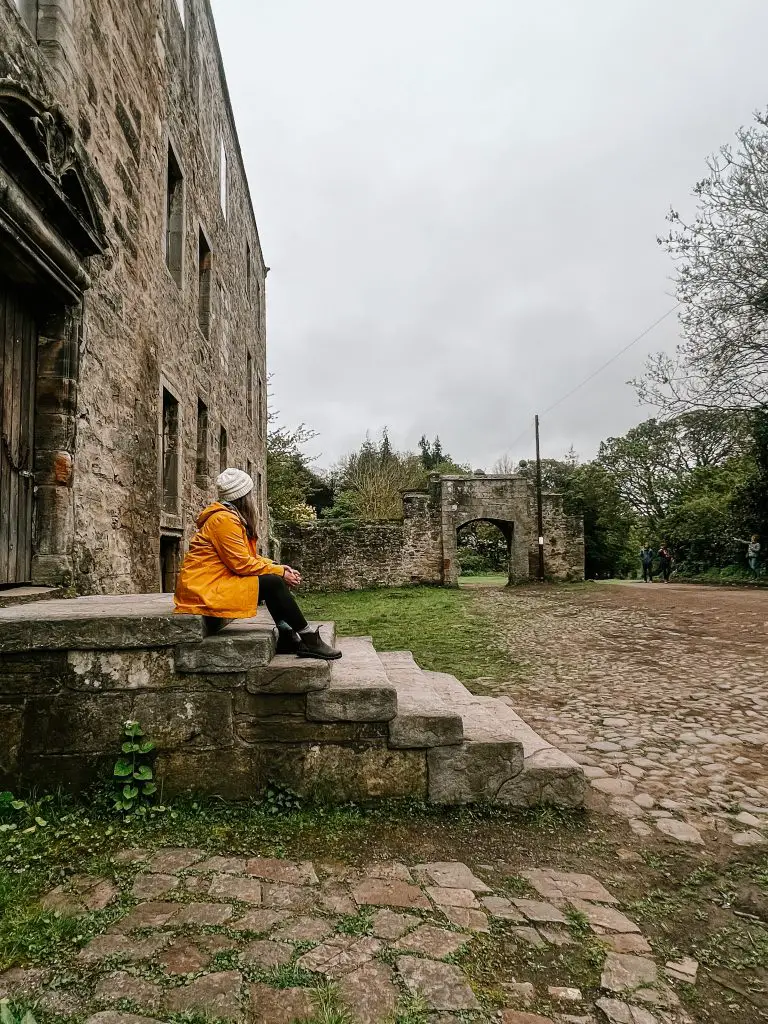 Me sitting on the steps of Midhope castle in Scotland.