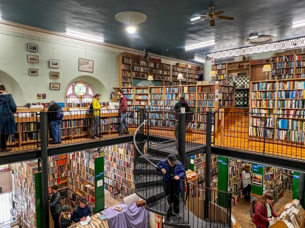 Interior of Leaky's Bookshop with rows of books and a spiral staircase.