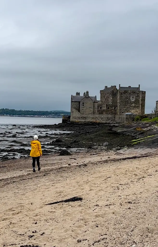 Me walking on the beach towards Blackness Castle in Scotland.