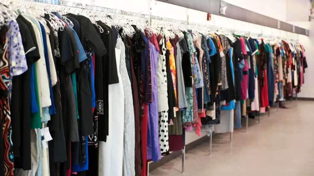 Clothes hanging on a rack at a thrift store.