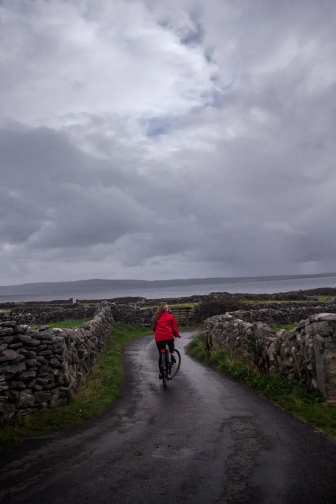 Riding a bike down a windy lane on a stormy day in Ireland.