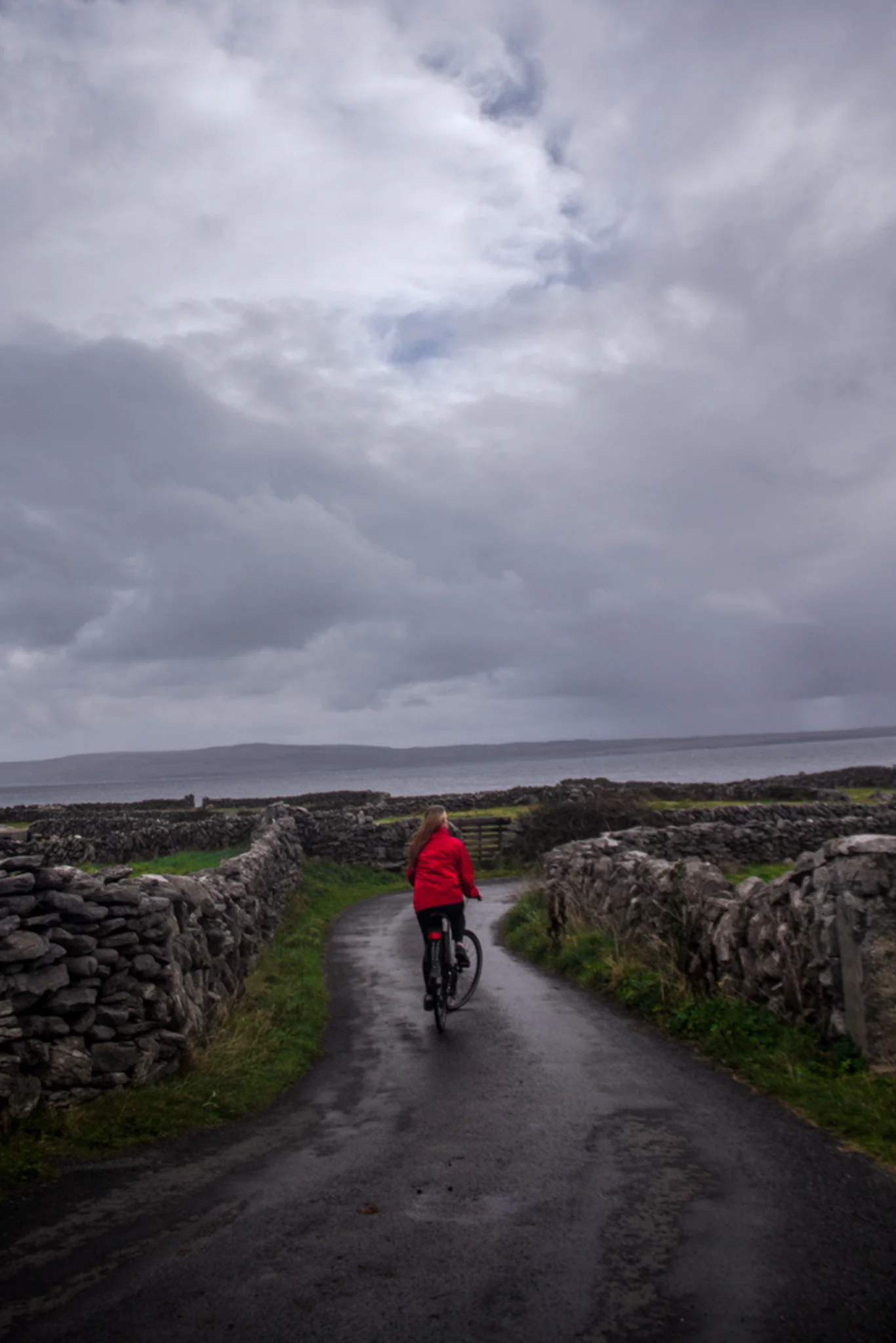 Riding a bike down a remote path on the Aran Islands.