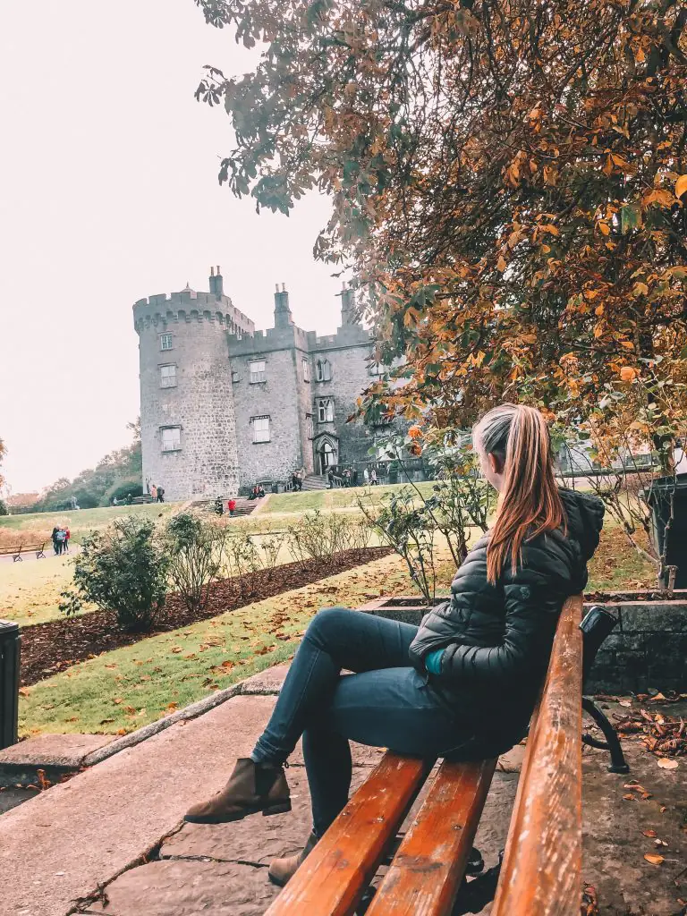 Sitting on a bench in front of Kilkenny castle.