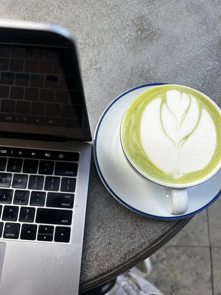 Caffe Central matcha latte and laptop.