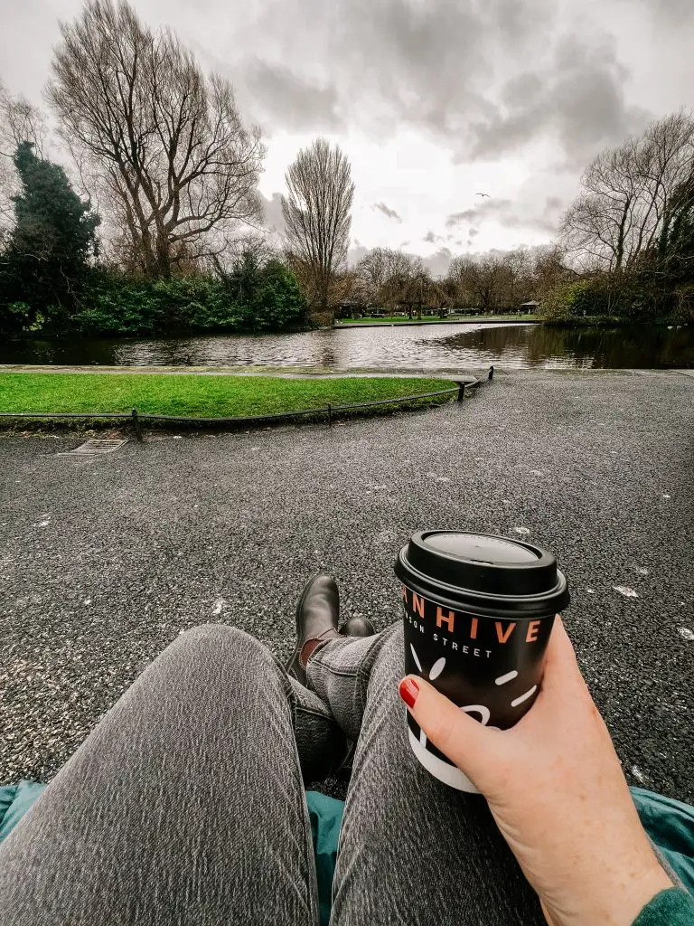 Holding a coffee cup looking over St. Stephen's Green. 