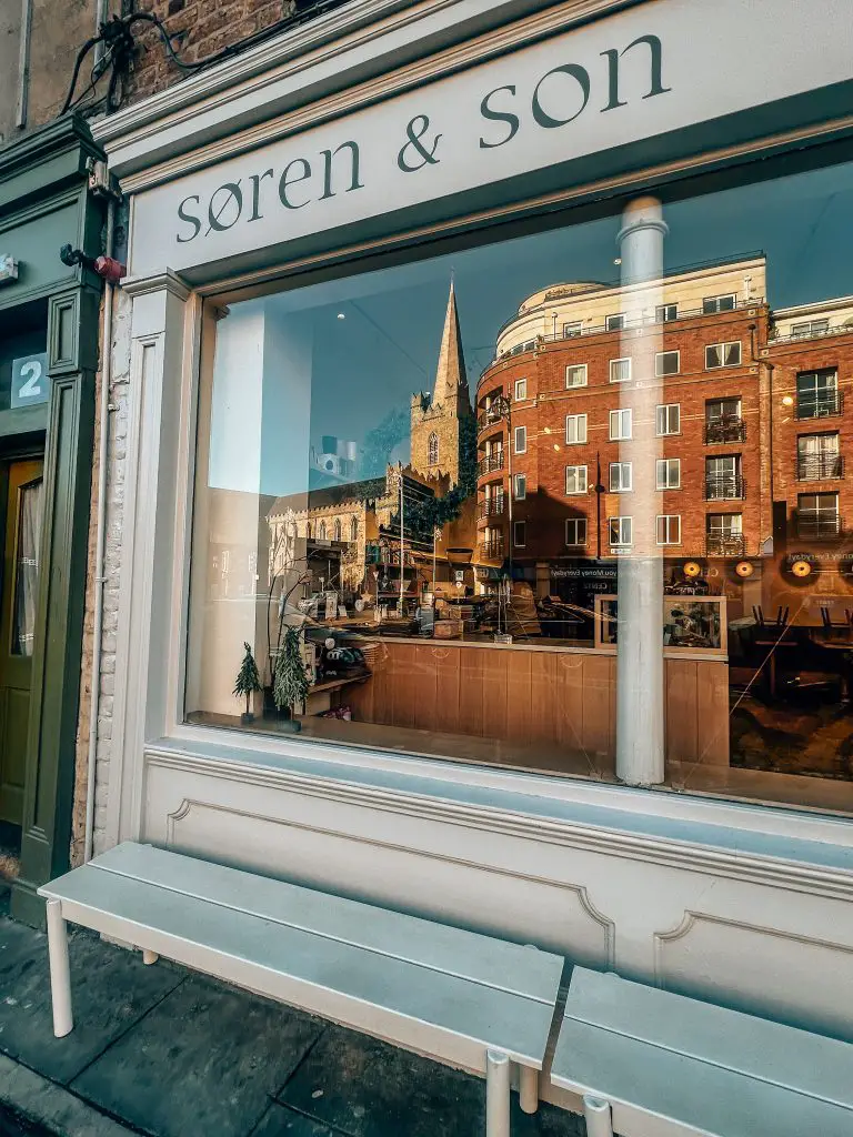 Exterior of Soren & Son with St. Patrick's Cathedral in the window reflection. 