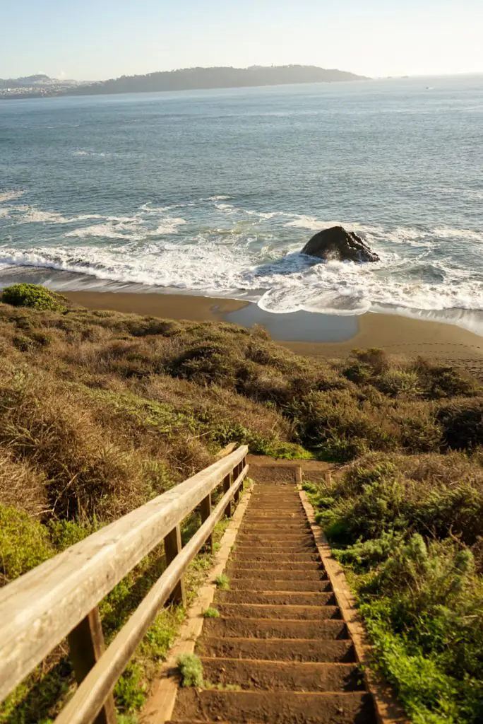 Beach stairs leading to black sand beach.