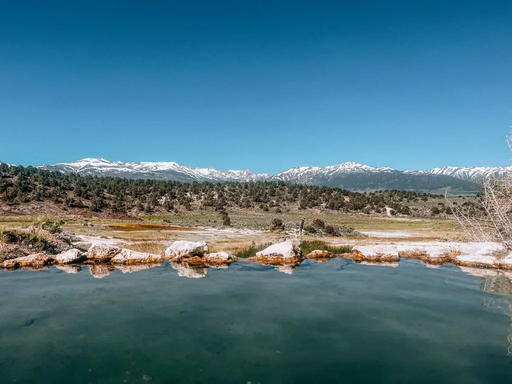 Travertine Hot Springs with the snow capped mountains in the distance.