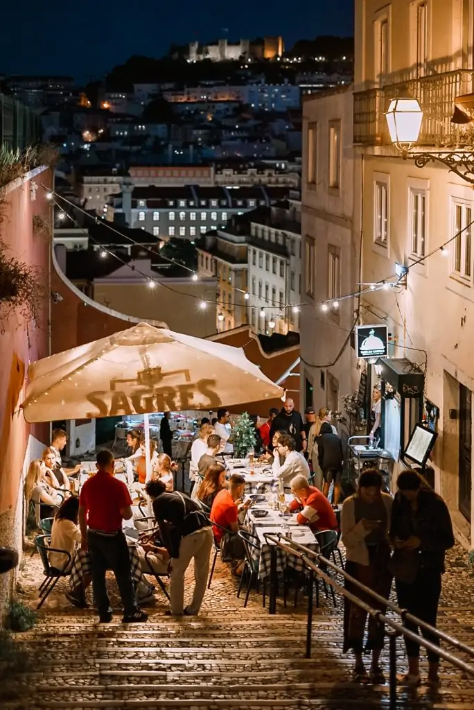 People eating dinner on the street in Lisbon, Portugal.