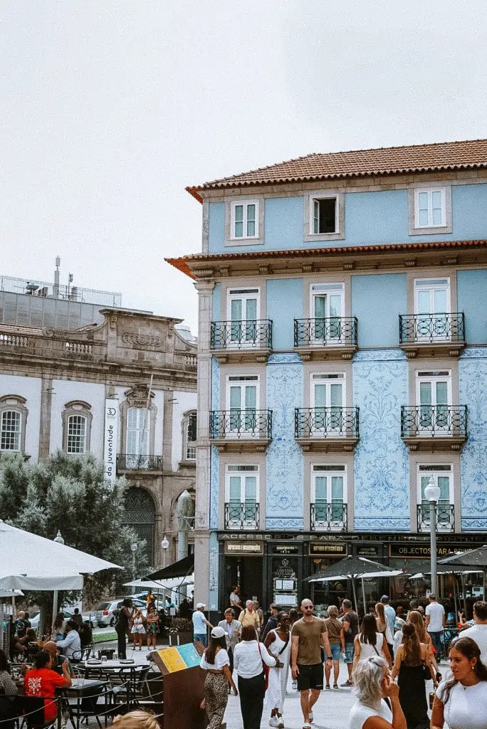 Square with a blue tiled building in Porto, Portugal