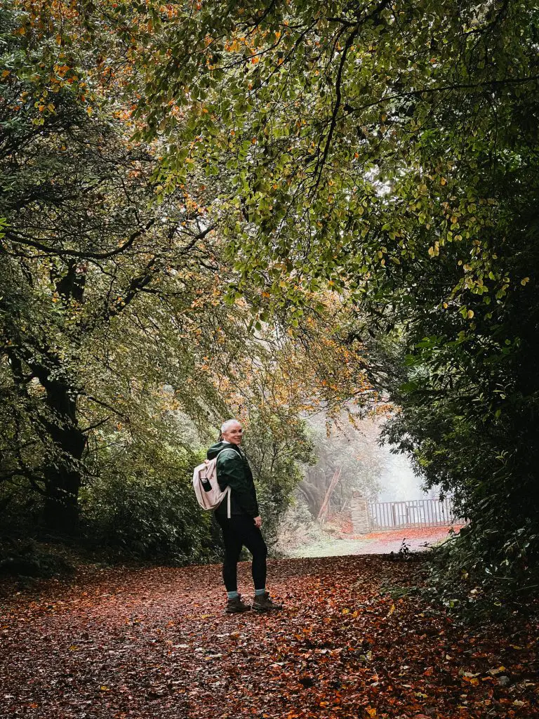 Katie standing on a wooded pathway in Sligo, Ireland.